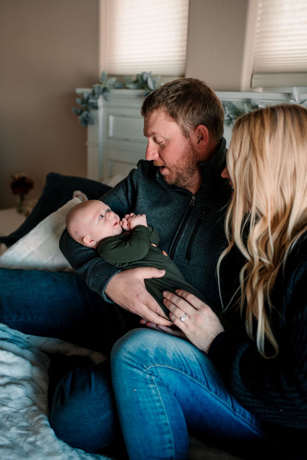Intimate lifestyle photography session capturing playful moments on a bed.