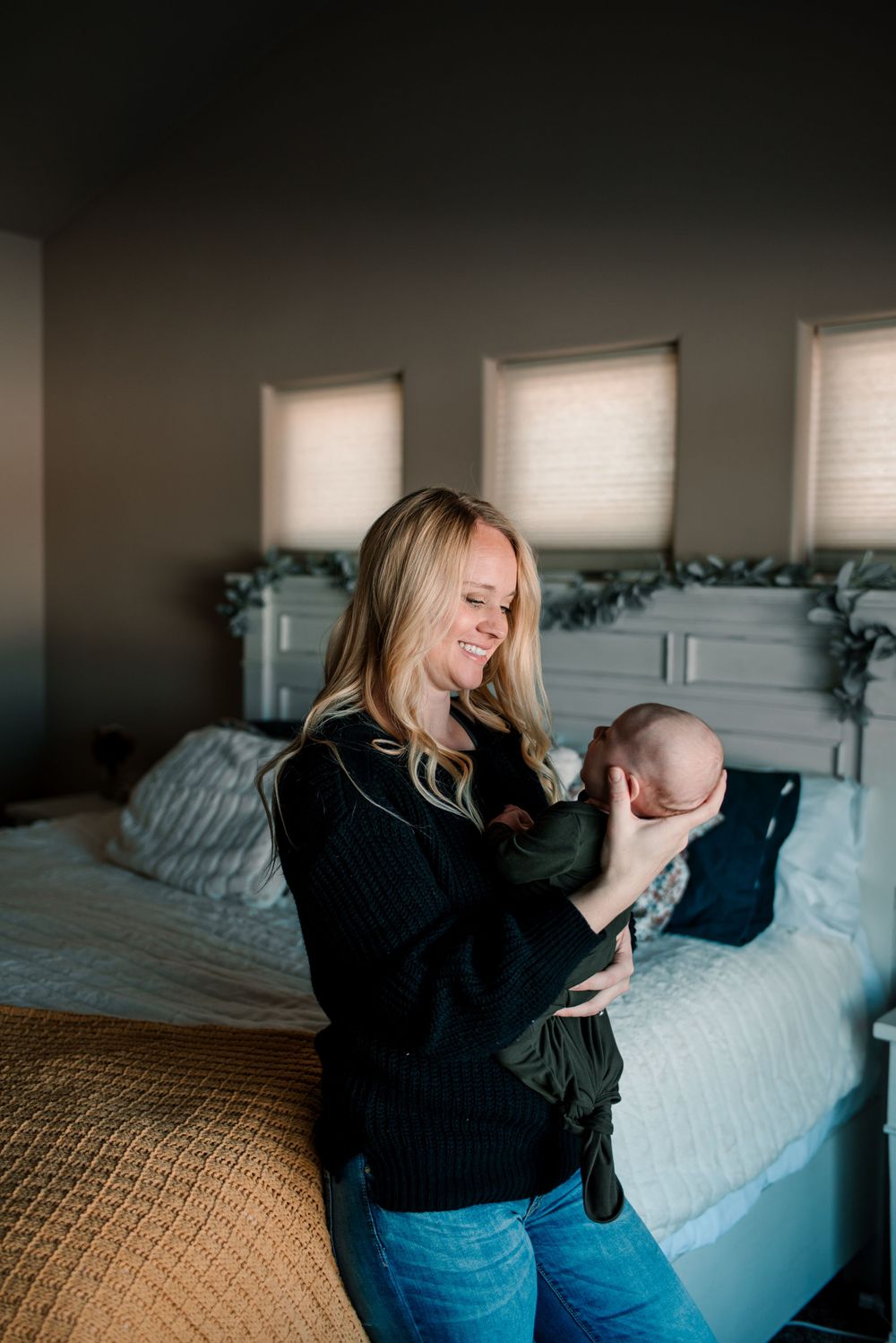 Candid lifestyle photos showing tender moments between a couple on a bed.