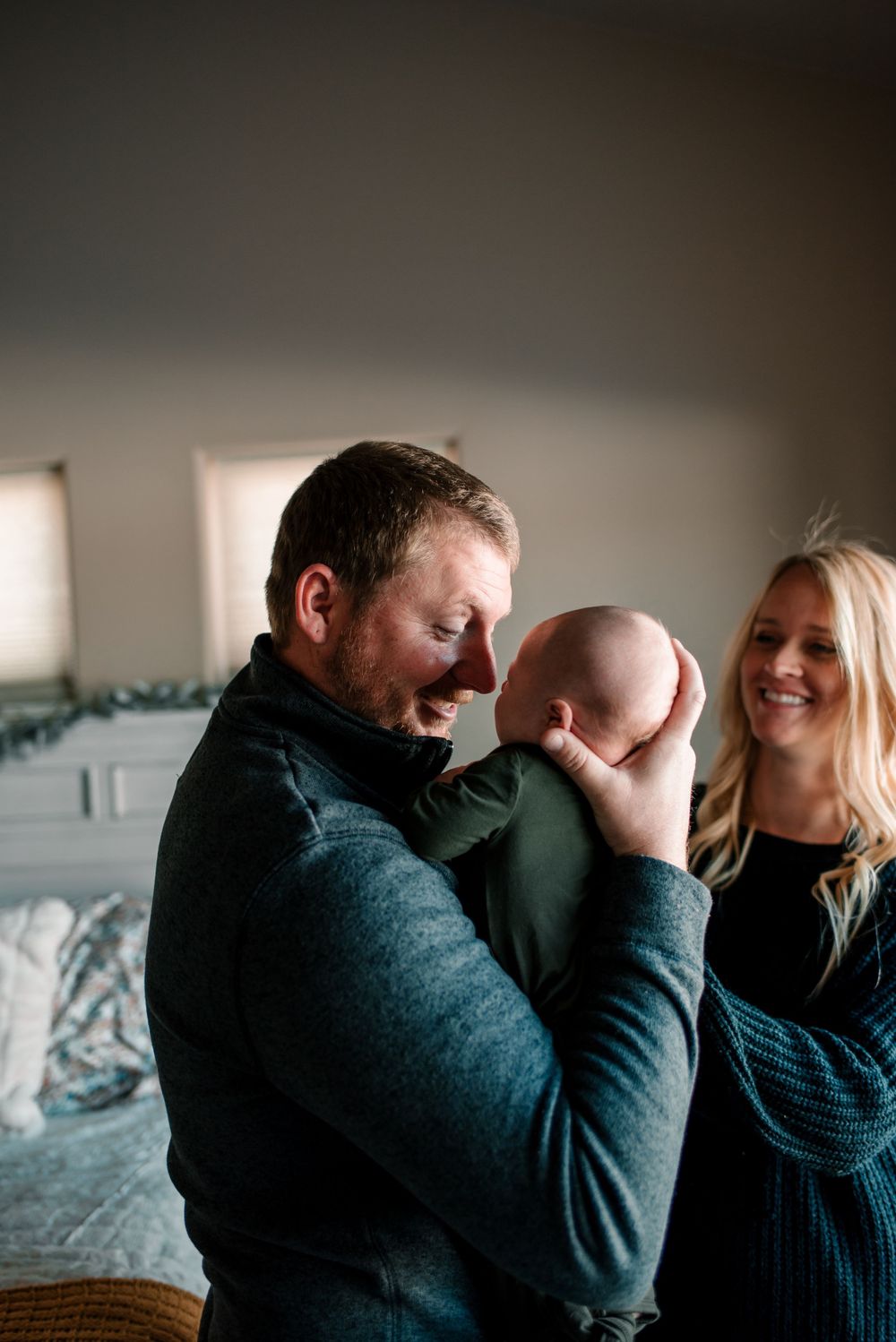 Emotional lifestyle photography session showing tender family moments in a bedroom.