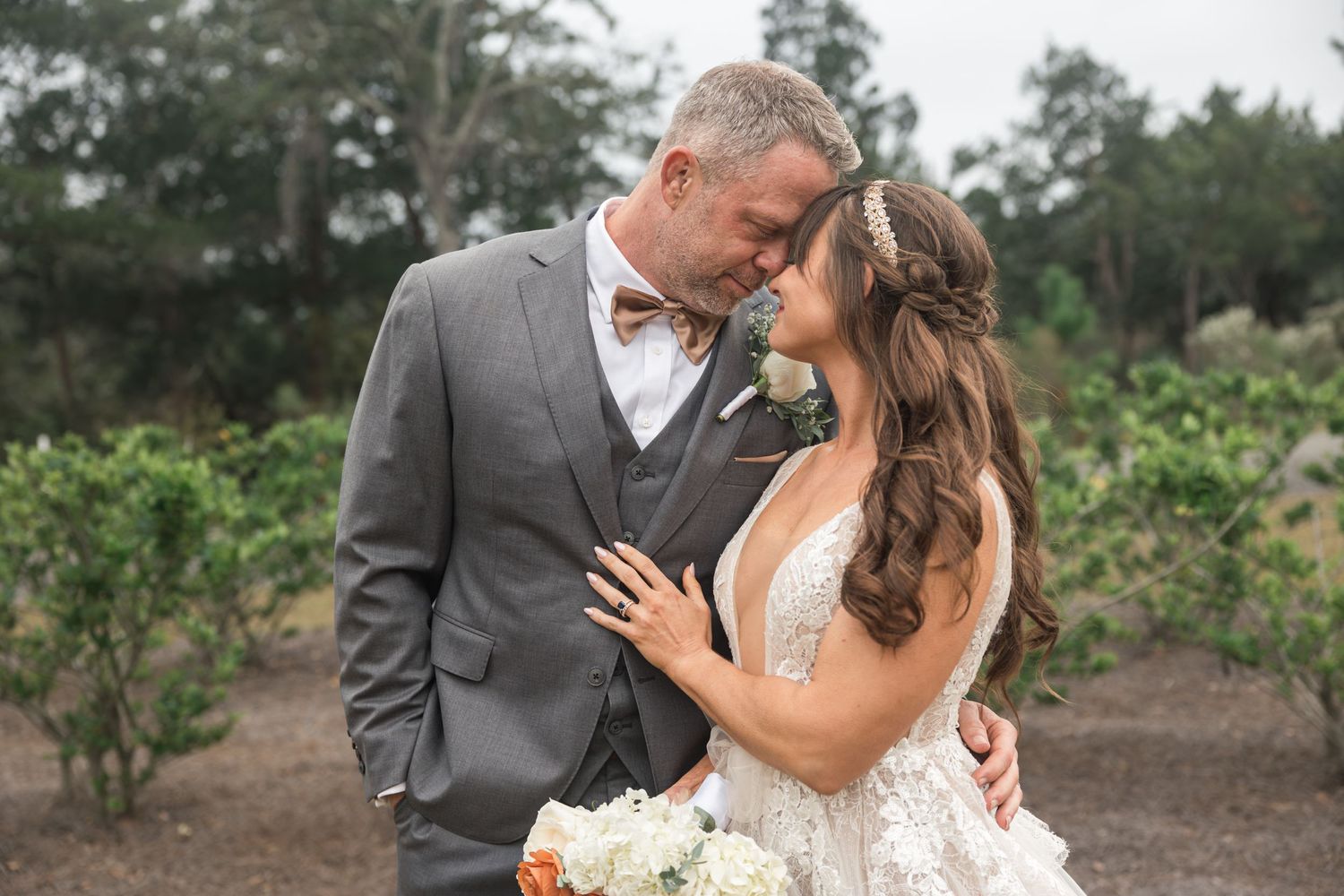 Couple sharing romantic moments during outdoor wedding photoshoot.