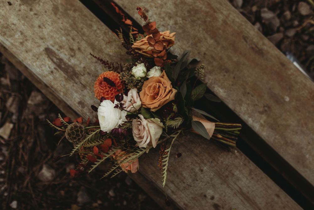 Montreal wedding photographer captures moody orange tone autumn wedding bouquet
