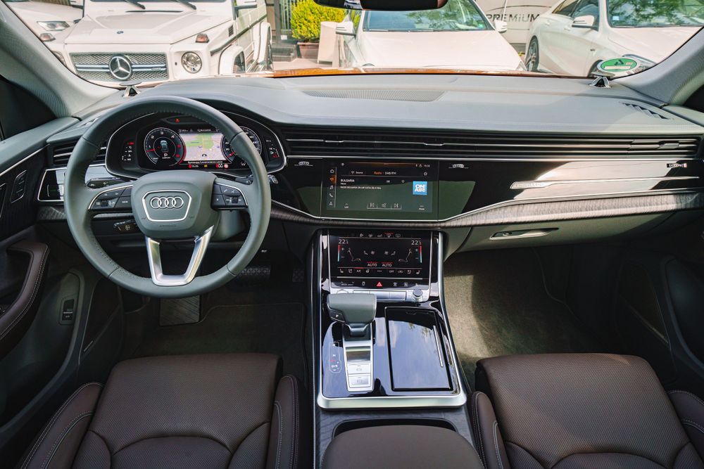 Audi Q8 dashboard with leather-wrapped steering wheel and digital instrument display.