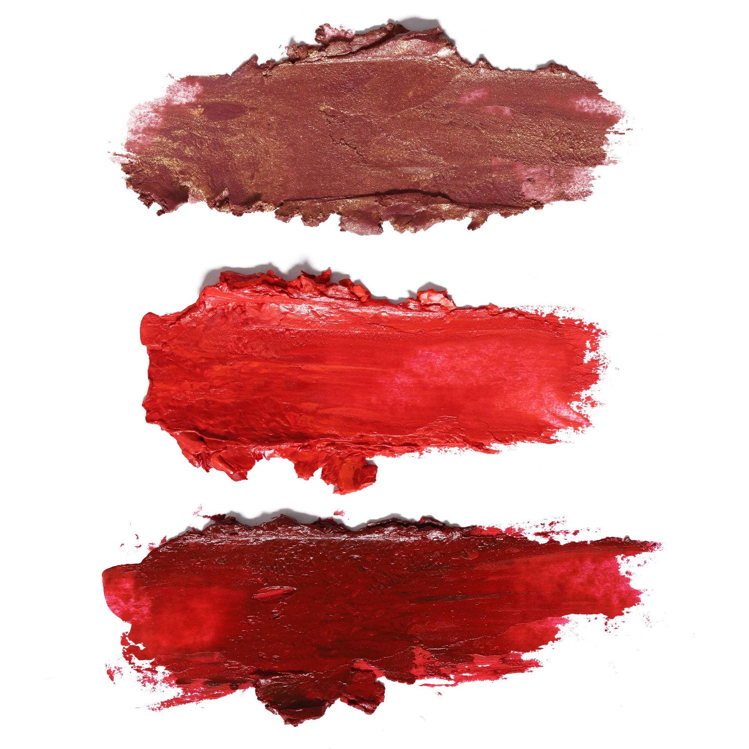 Three swatches of red and brown lipstick textures.