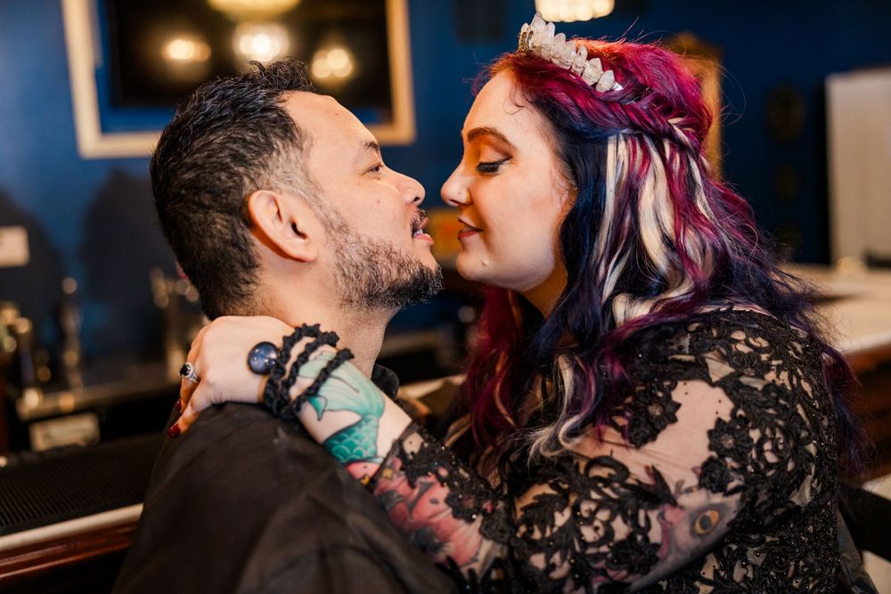 couple kissing at speakeasy bar