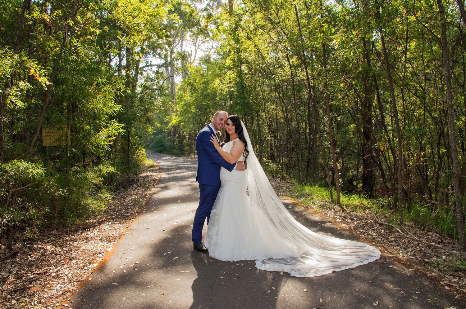 bride and groom embracing surrounded by greenery