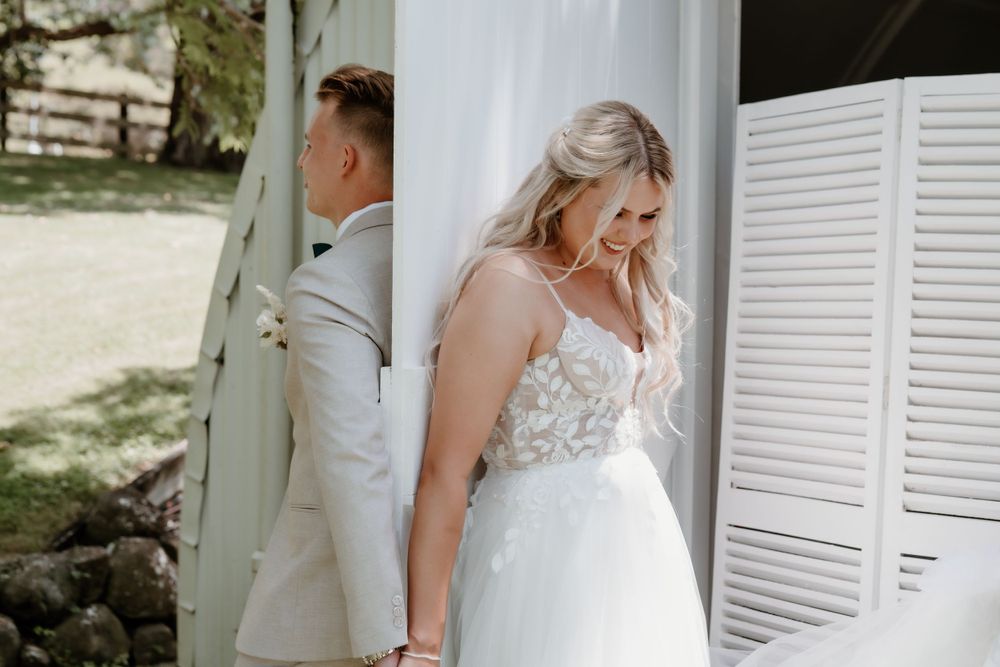 Couple shares first touch moment before wedding ceremony.