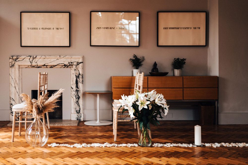 The wedding ceremony room at Cowley Manor flowers and art work no people