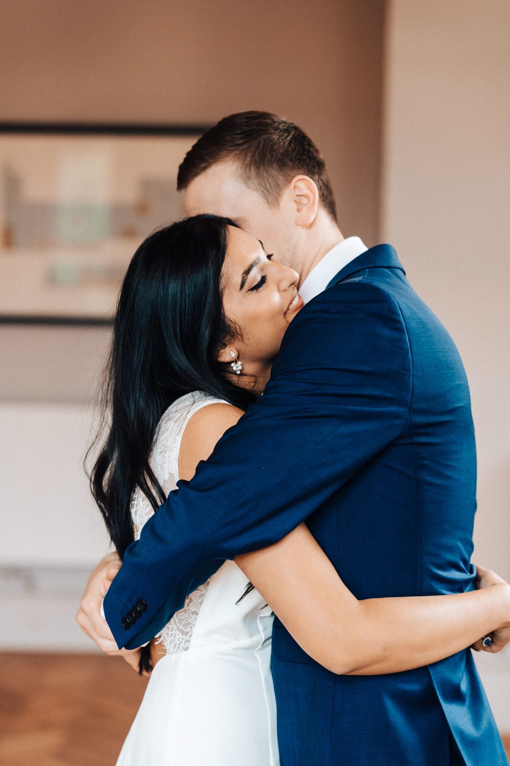 Bride and groom having a loving in brace after first case at their ceremony at Cowley Manor