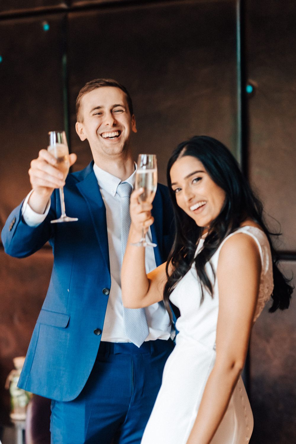 Very happy bride and groom saying cheers to the photographer family and friends