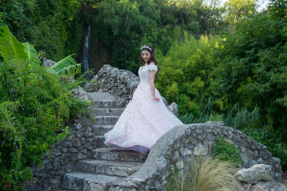 girl showing off pink dress. greenery. japanese garden. San Antonio, Texas. wedding photographer