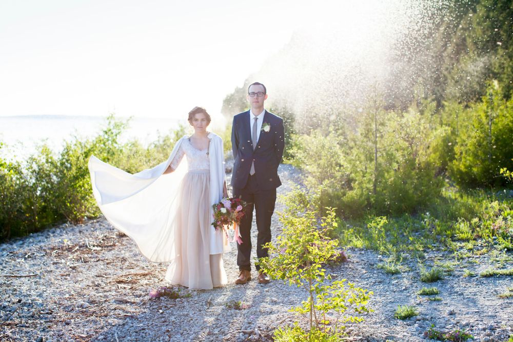 Wedding photography by Sparrow and Bean Studio. Wedding photograph of bride and groom on Michigan beach at sunset.