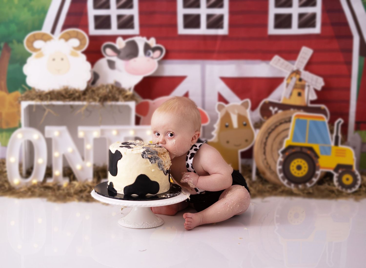 Baby boy eating cake at his cake smash photographed by cake smash photographer swansea