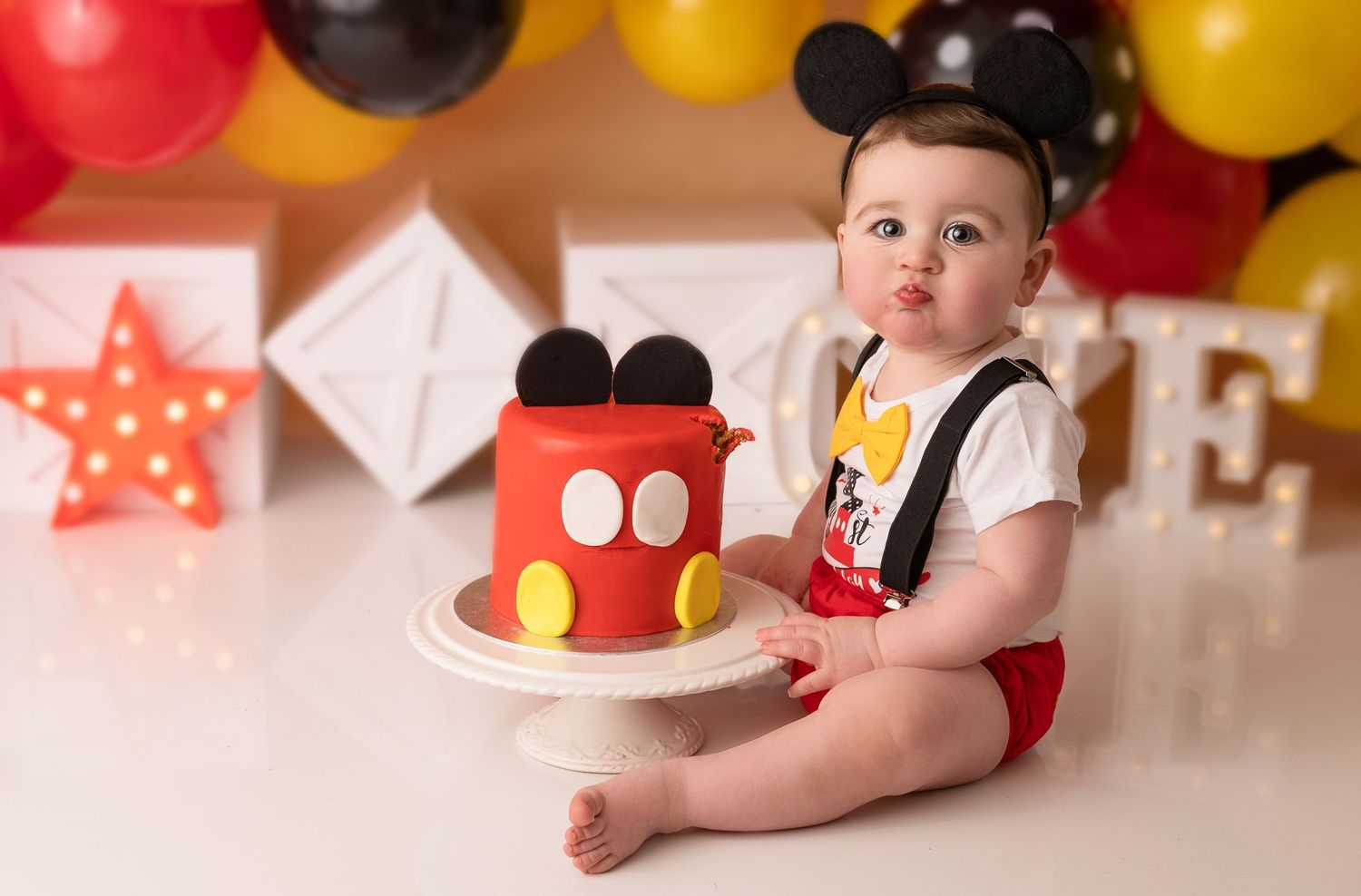 Baby boy at his cake smash photographed by cake smash photographer swansea