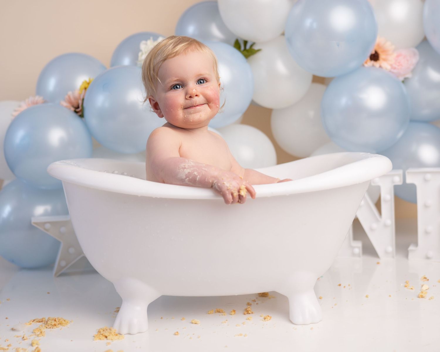 Baby girl in bath at her cake smash photographed by cake smash photographer swansea