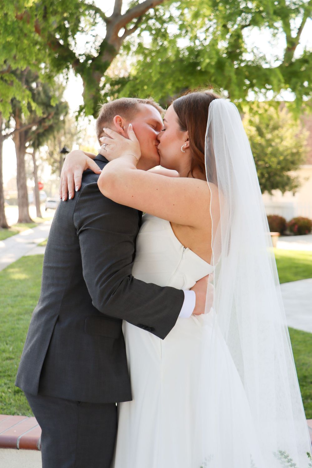 Intimate wedding portraits captured outdoors with natural greenery backdrop.