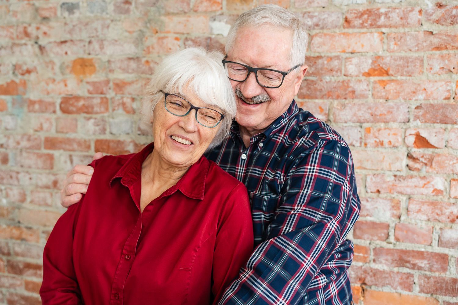 Grandparents cuddle together.