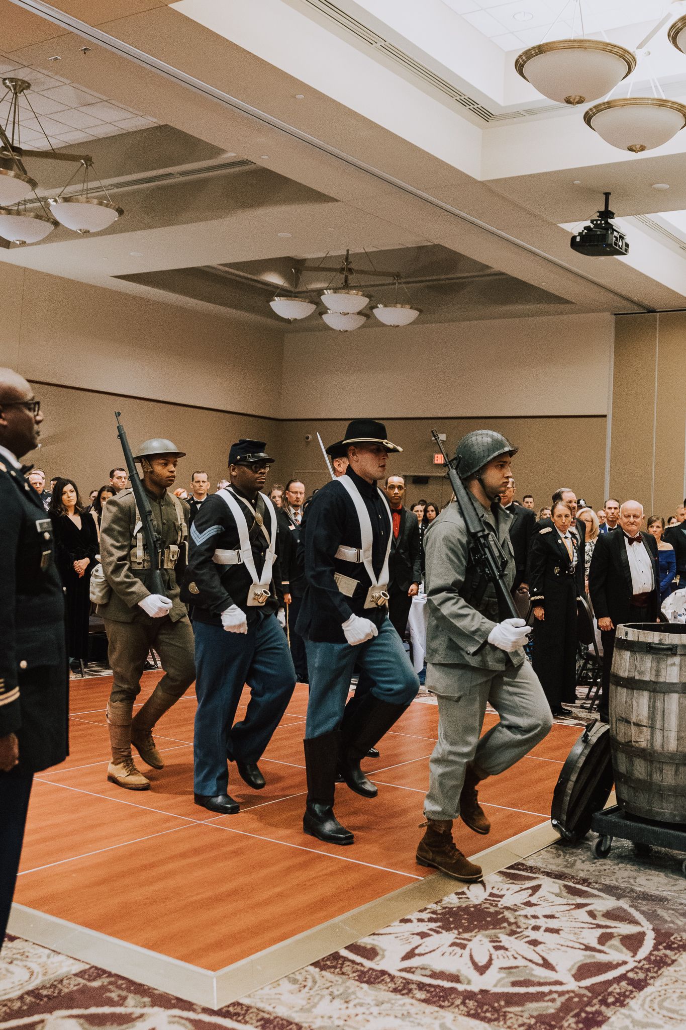soldiers marching in formation in historic uniforms during military ball opening ceremony