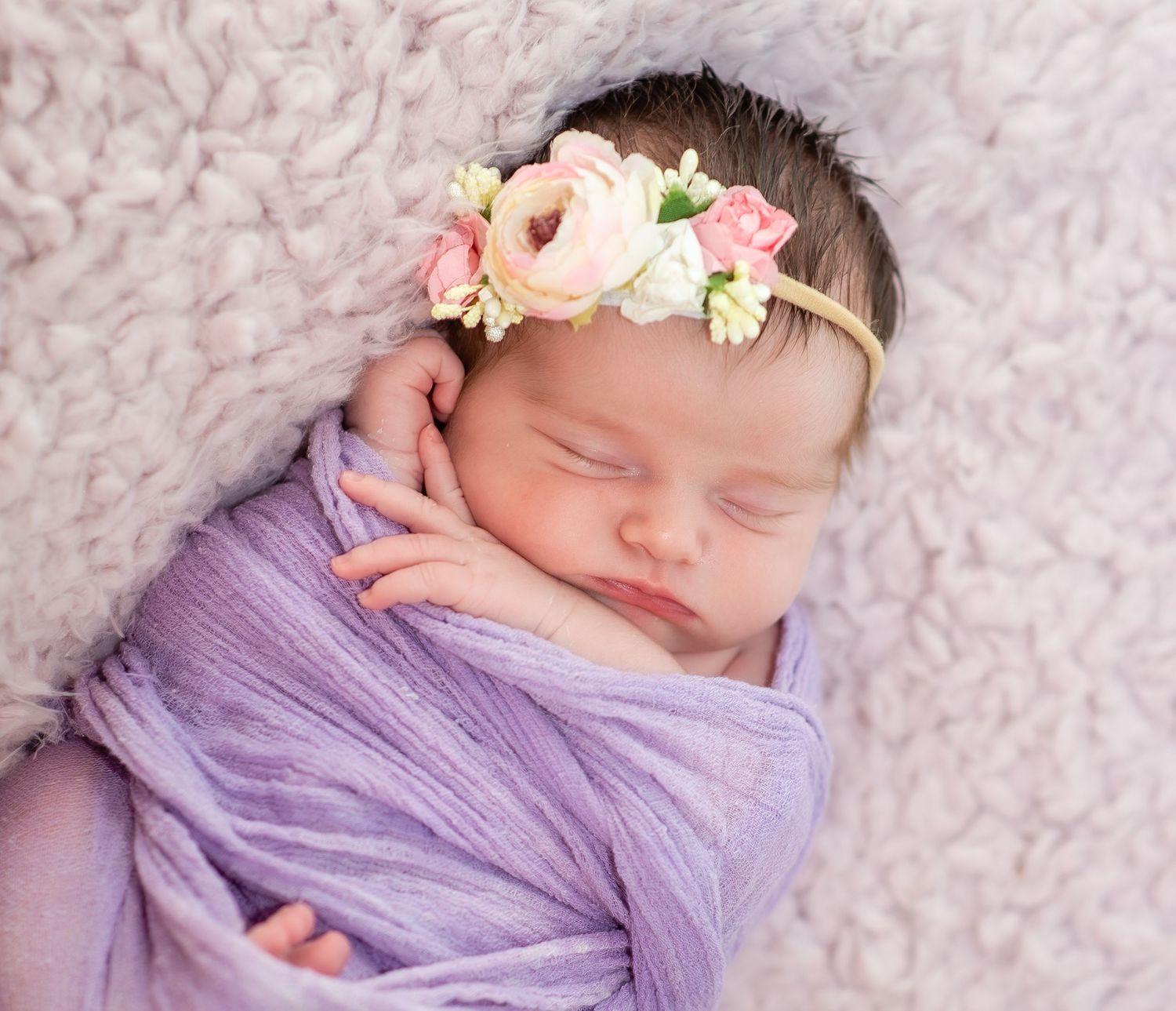 newborn baby girl pose natural light photography studio session wraps and headband and custom creative set memory captured smile Alabama