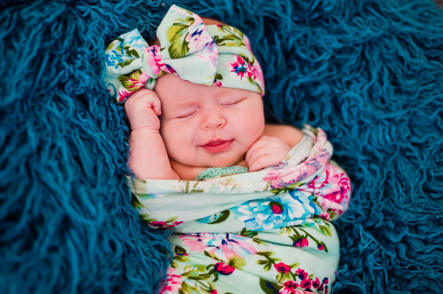 Newborn baby girl swaddle wrapped headband soft focus sweet baby little bundle of smile captured sleepy baby Alabama Fairhope