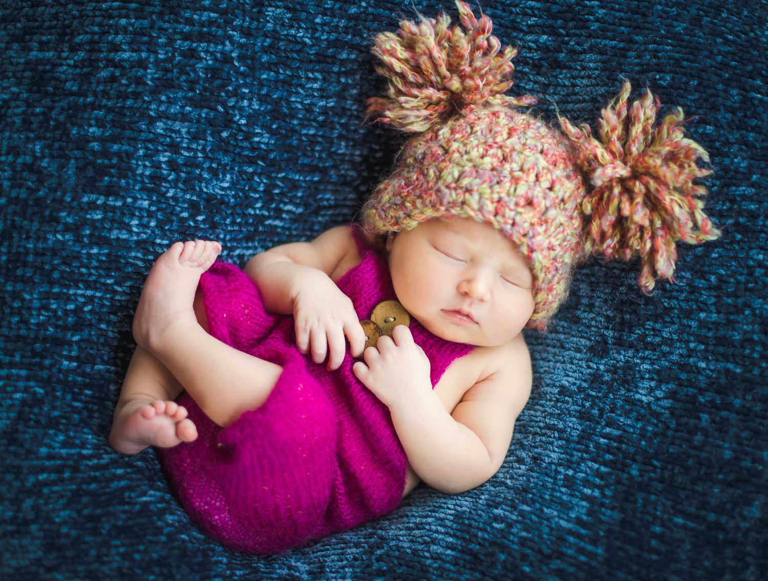 newborn baby girl pose natural light photography studio session wraps and crochet hat and custom creative set memory captured smile Alabama