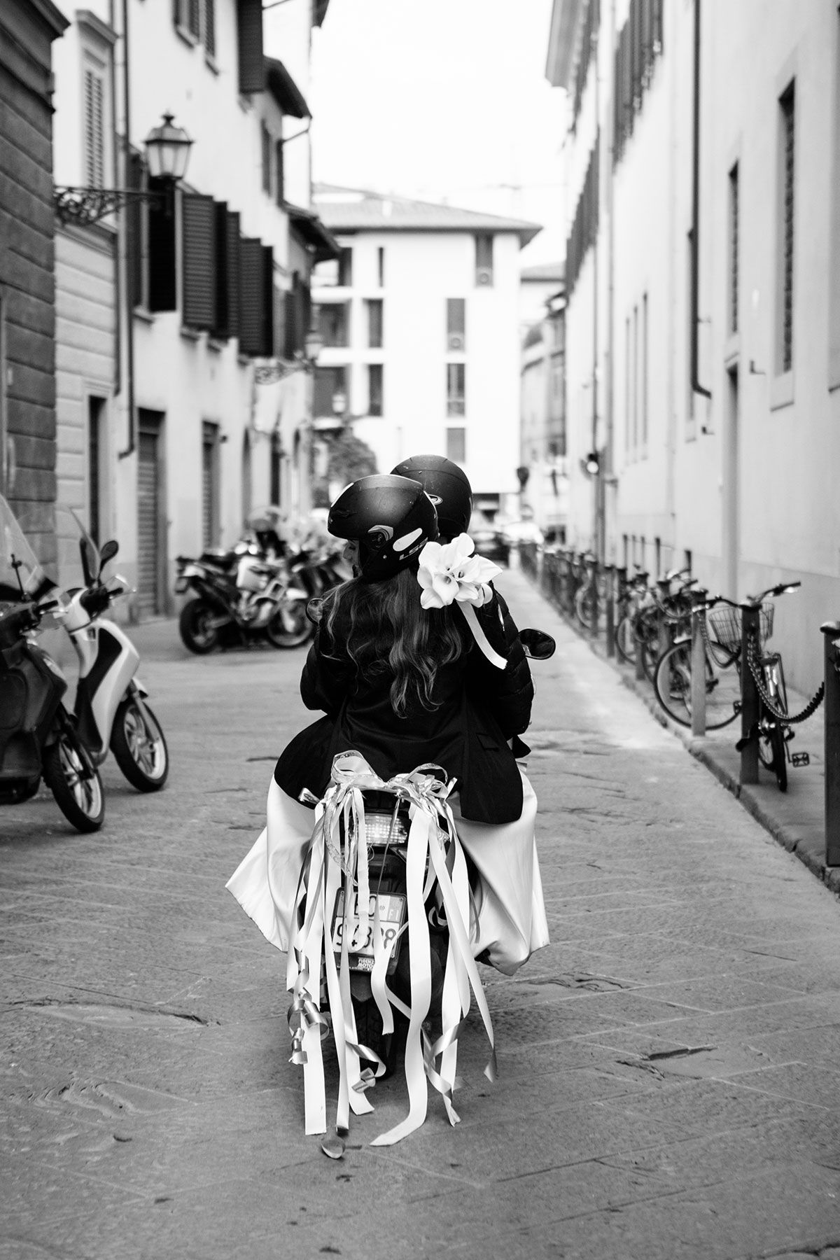 bride and groom on a moped following their elopement in Florence captured by wedding photographer Elizabeth Armitage