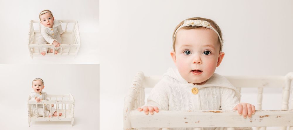 Infant girl on white backdrop in white crib Huntington IN studio