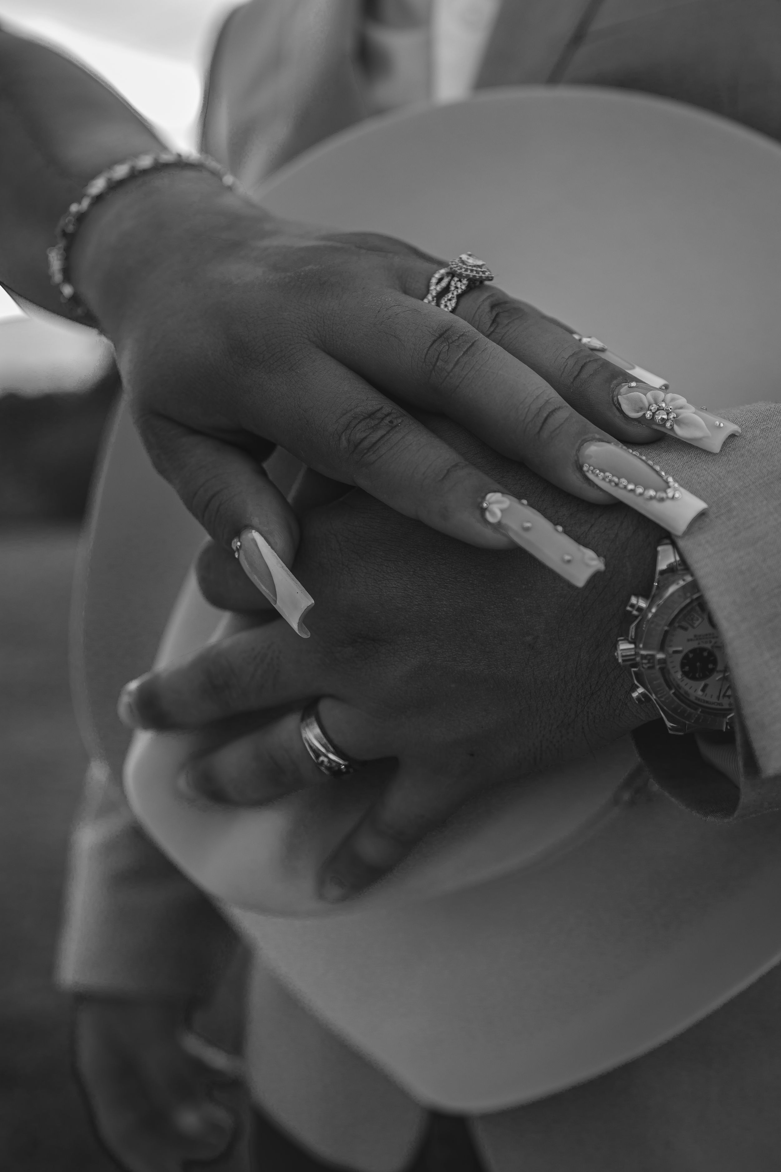 Hands hold paper sheets in a sequence demonstrating a page-turning motion in black and white photography.