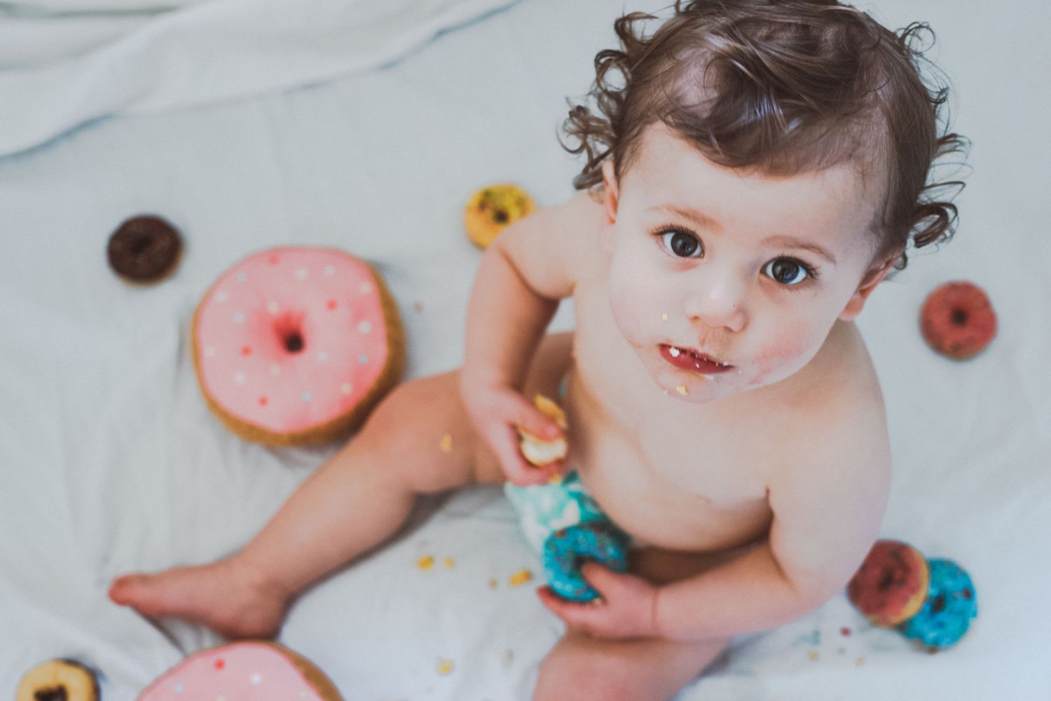 Baby eating a crumby cake
