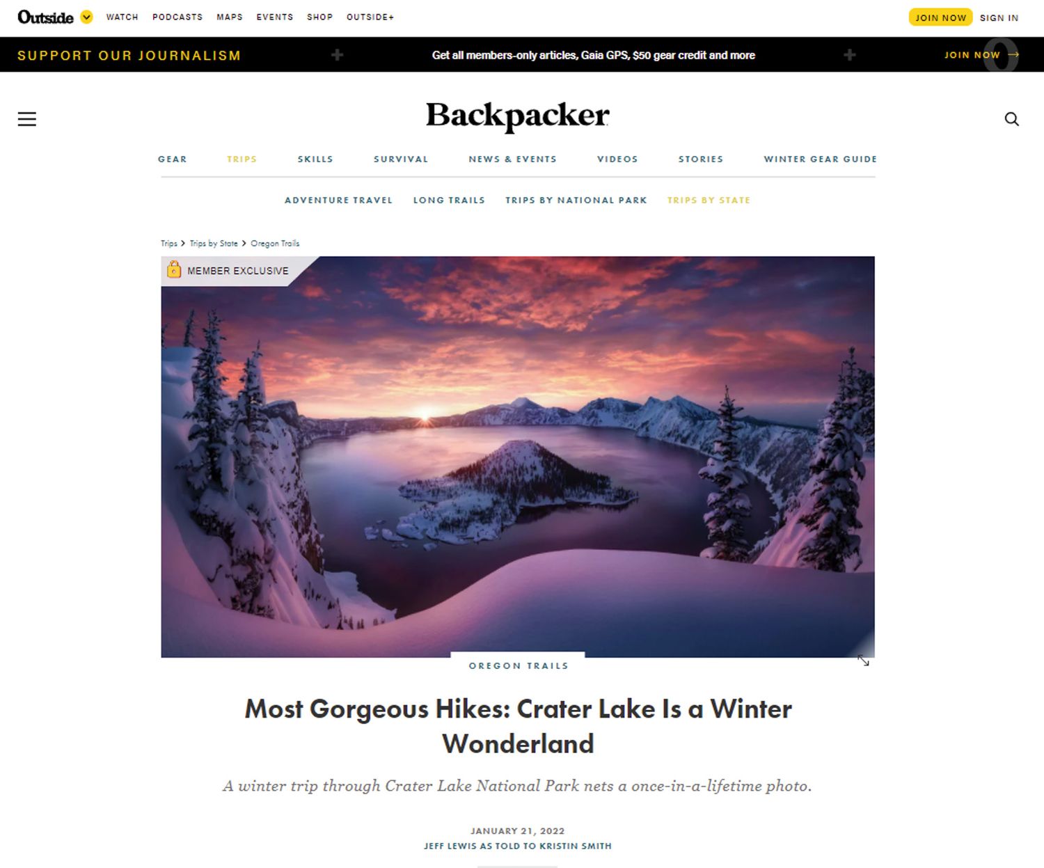 A scenic winter landscape of Crater Lake National Park at sunset with snow-covered trees and pink-purple sky.