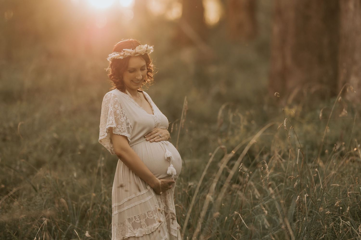 Golden hour outdoor portrait session featuring couple in natural field setting.