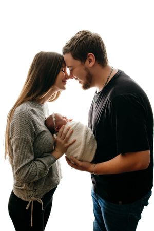 Silhouetted family portrait series against white background showing tender moments.
