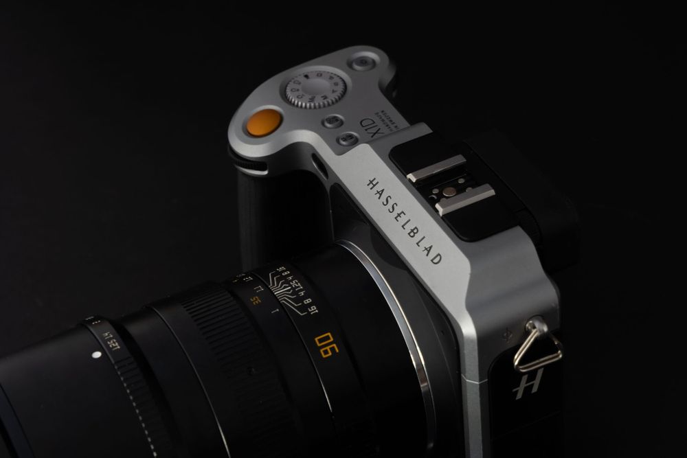 Close-up view of a grey camera hot shoe mount against dark background.