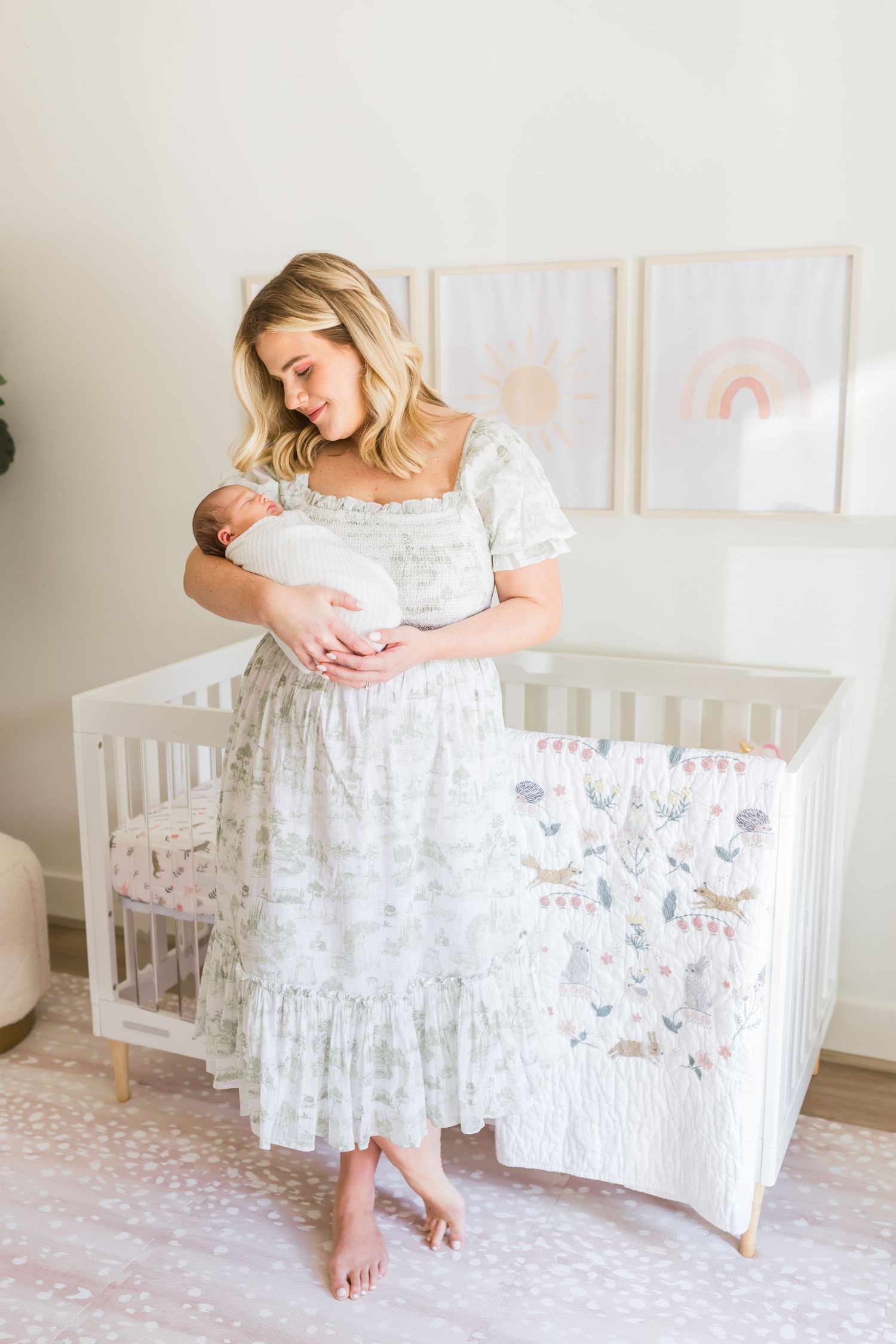A nursery scene with a floral dress and white crib featuring cute animal print bedding.