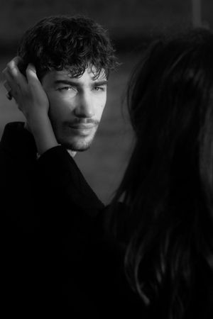 Intimate black and white portrait of couple sharing tender moment.