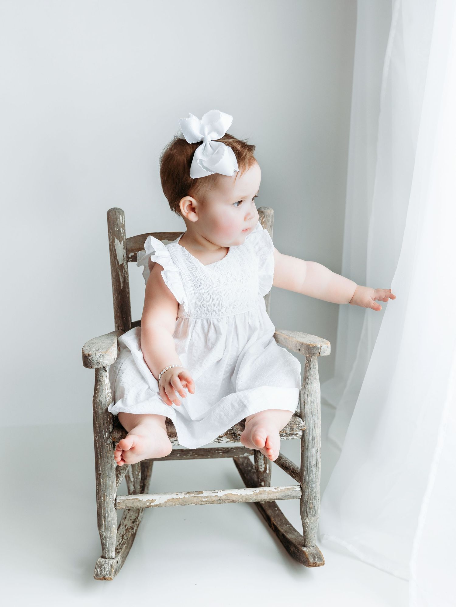 A milestone session of a little girl in a chair. Greenville SC newborn photographer, Easley, SC newborn photographer, Upstate SC newborn