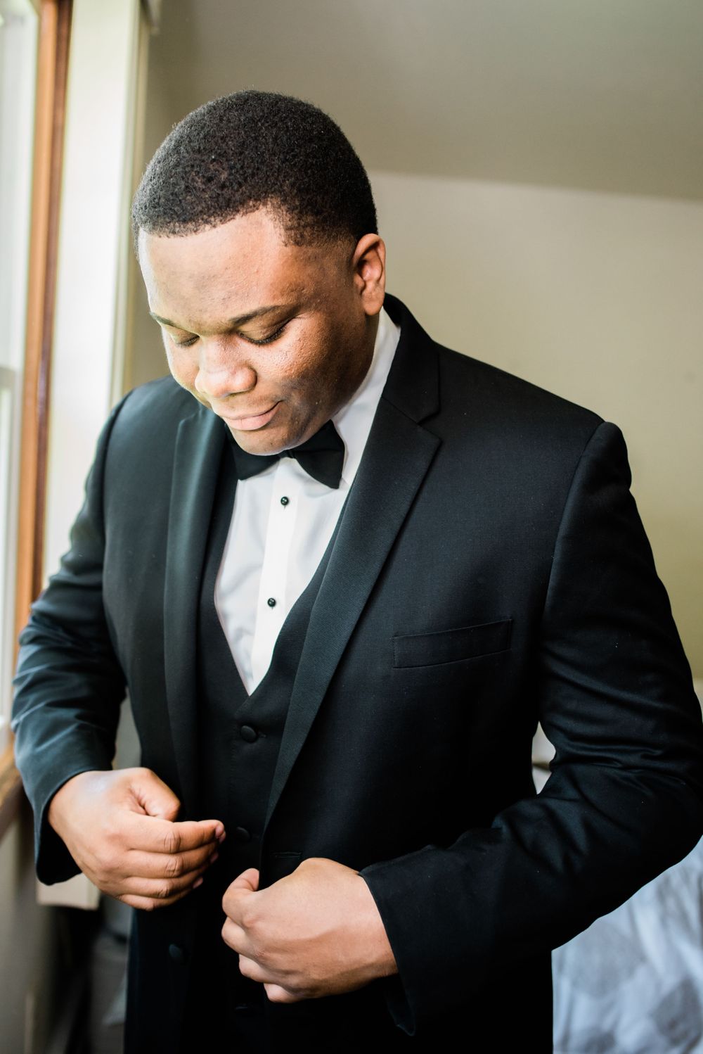 groom portrait by window
