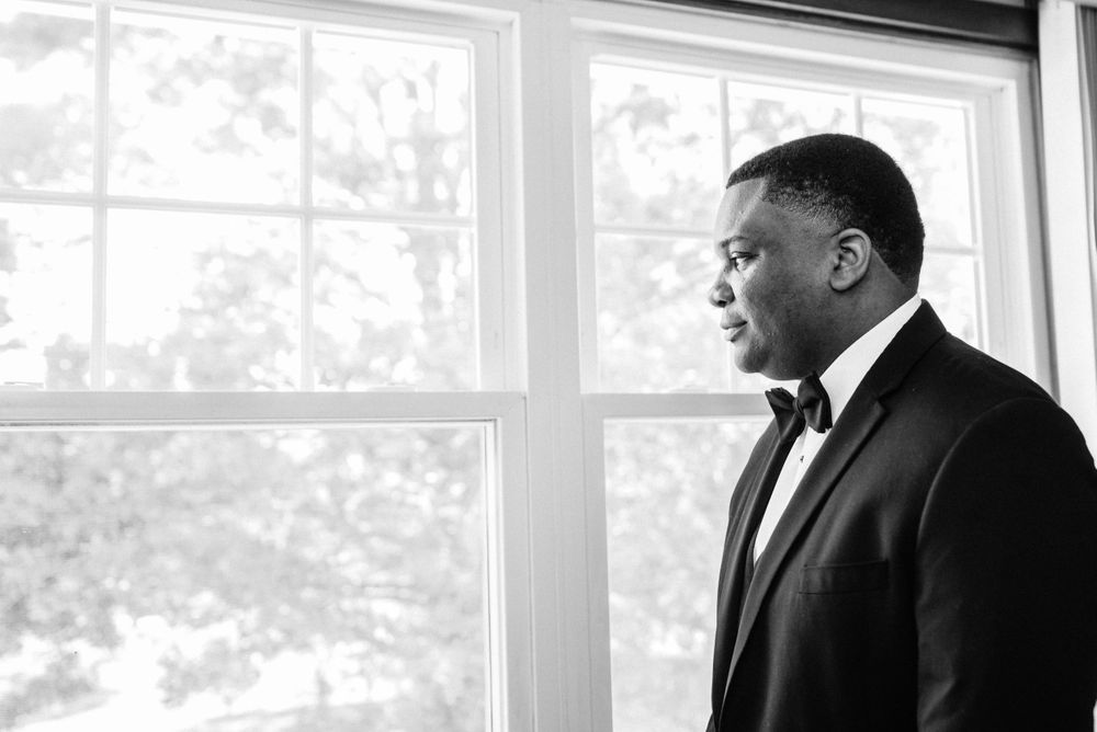 groom portrait by window