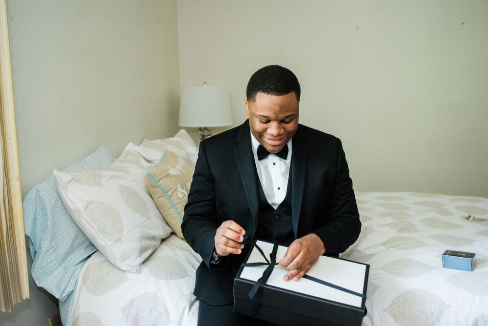 groom opening wedding gift box