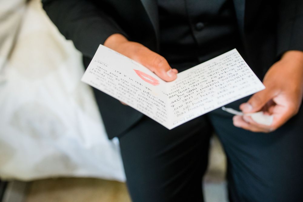 groom holding card in hand