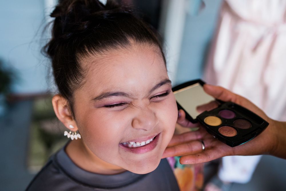 junior bride getting makeup done