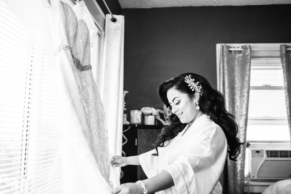 bride admiring wedding dress