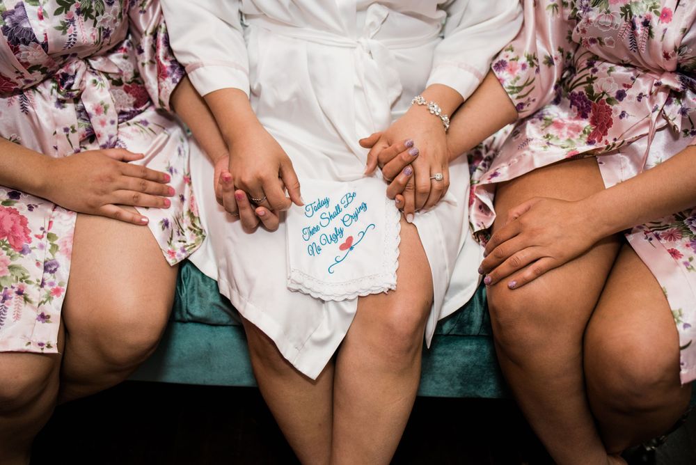 bride and sisters holding hands
