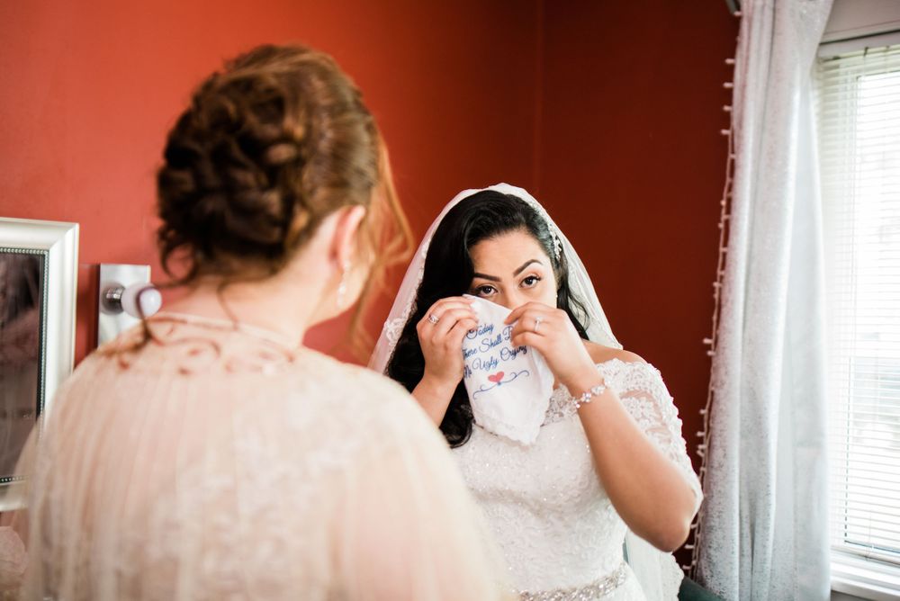 bride using hanker-chief to wipe tears away