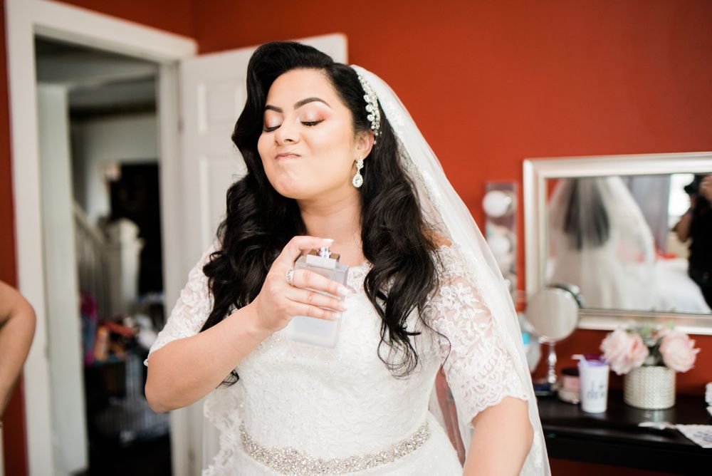 bride spraying on perfume