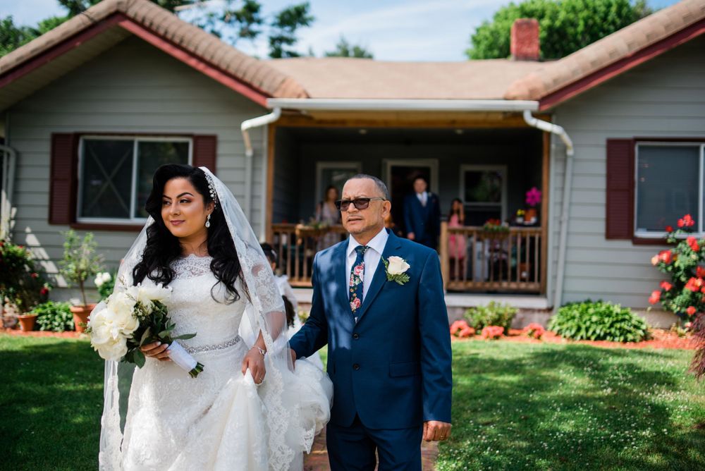 bride walking with dad toward car