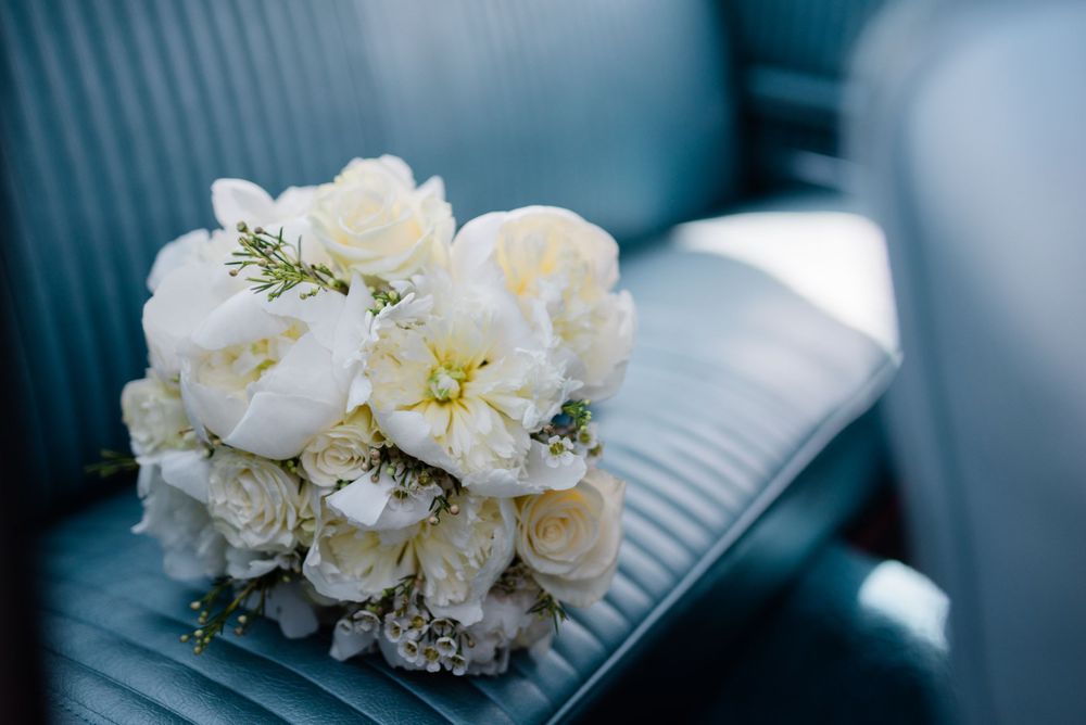 wedding bouquet on back seat of vintage car