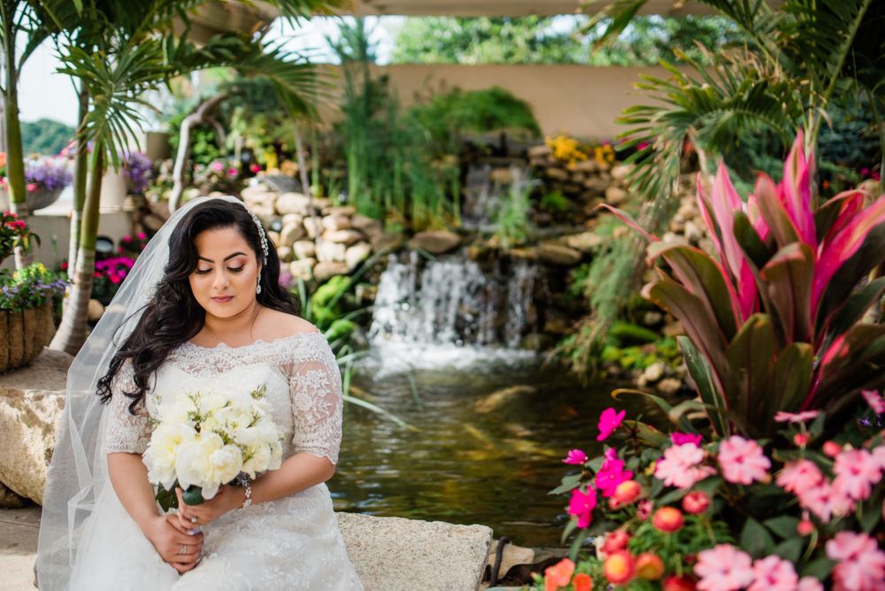 bride portrait sitting by flowers