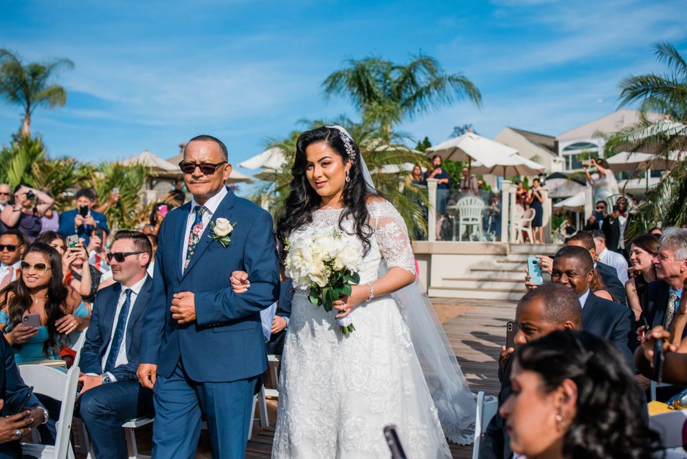father and bride walking down the aisle