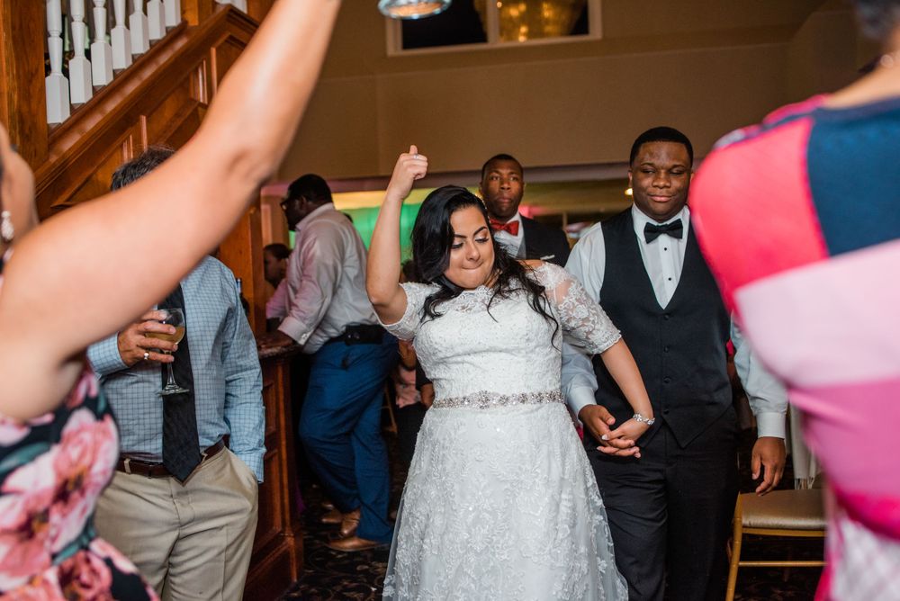 bride and groom dancing at reception with guest