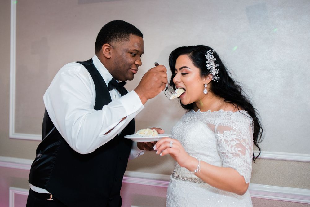 groom feeding cake to bride